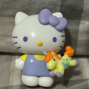 Hello Kitty Holding A Toy Unicorn Figurine
